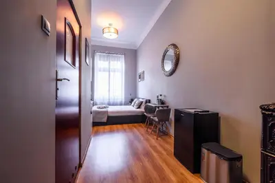 a hallway with a room with a bed and a table at Loc8 Apartments by Cracovia Prime in Kraków