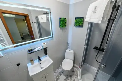 a bathroom with a toilet and a sink and a shower at Loc8 Apartments by Cracovia Prime in Kraków