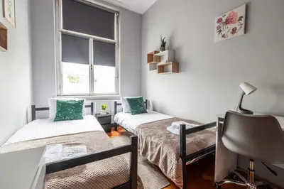 a room with two beds and a window at Room8 Apartments by Cracovia Prime in Kraków