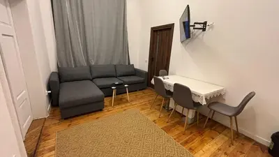 a living room with a couch and a table and chairs at Stradom House Apartment in Kraków