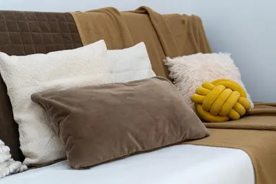 a couch with pillows and a stuffed animal on it at Near Wawel Castle in Kraków