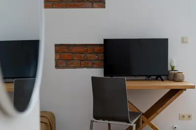 a desk with a computer monitor on top of it at Near Wawel Castle in Kraków