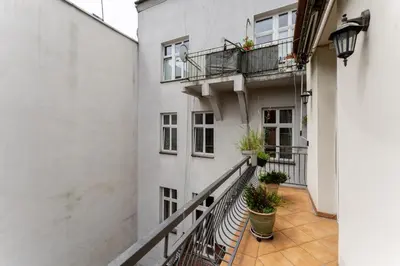 a balcony of a building with potted plants at Near Wawel Castle in Kraków