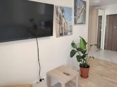 a living room with a large flat screen tv on the wall at Quiet in the City Wrocławska in Kraków