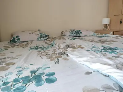 a bed with two pillows on top of it at Quiet in the City Wrocławska in Kraków
