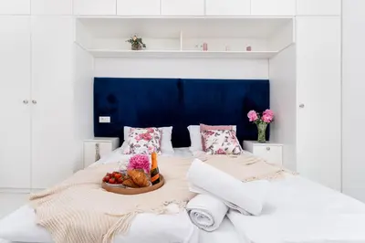 a bedroom with a bed with a bowl of fruit on it at Malila Premium Apartments Cracow Tauron Arena Lema 15E in Kraków