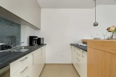 a kitchen with a sink and a counter top at Kaleidoscope Apartment by Tyzenhauz in Kraków