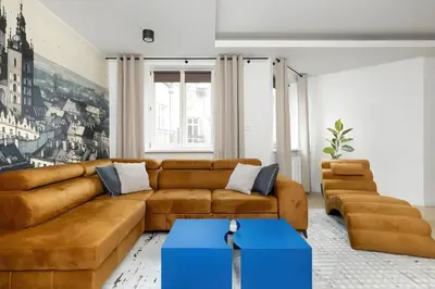 a living room with a brown couch and a blue box at Kaleidoscope Apartment by Tyzenhauz in Kraków