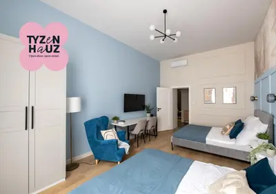 a bedroom with a bed and a desk with a chair at Kaleidoscope Apartment by Tyzenhauz in Kraków