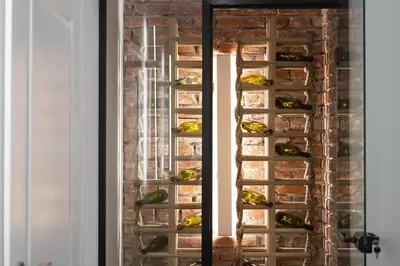 a wall of wine bottles in a brick wall at Old Market View Premium Standard with AC in Kraków