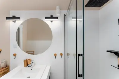 a bathroom with a sink and a mirror at Old Market View Premium Standard with AC in Kraków