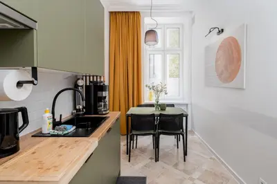 a kitchen with a table and a dining room at Old Market View Premium Standard with AC in Kraków