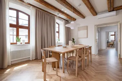 a dining room with a wooden table and chairs at Modern apartment in the heart of the Old Town in Kraków