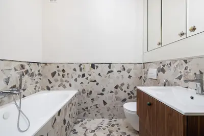 a bathroom with a tub and a sink and a toilet at Modern apartment in the heart of the Old Town in Kraków