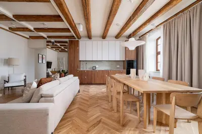 a living room with a couch and a table at Modern apartment in the heart of the Old Town in Kraków