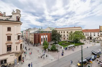 a group of people walking around a city street at Modern apartment in the heart of the Old Town in Kraków