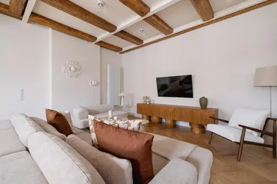 a living room with a couch and a table at Modern apartment in the heart of the Old Town in Kraków