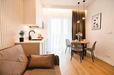 a living room with a couch and a table with chairs at Flower Blue 2 by Housine in Zator