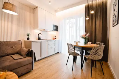 a kitchen and a living room with a table and chairs at Flower Blue 2 by Housine in Zator