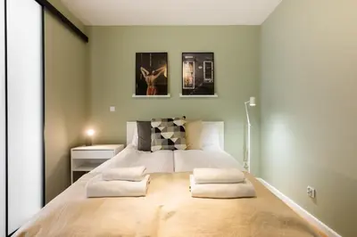 a bedroom with a large bed with two pillows at Przestronny apartament PARKING by NEARTOpl in Kraków