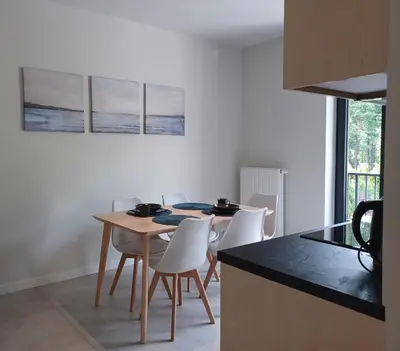 a kitchen with a table and chairs in a room at Apartament Parkowa 8 in Myślenice