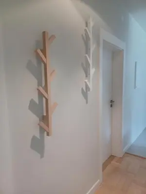 a room with three wooden shelves on the wall at Apartament Parkowa 8 in Myślenice