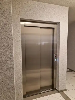 a stainless steel elevator door in a building at Apartament Ruczaj - Parking & Self Check-in in Kraków