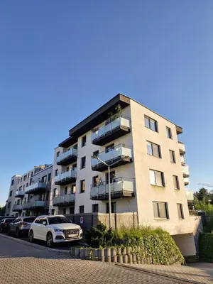 a large apartment building with cars parked in front of it at Apartament Ruczaj - Parking & Self Check-in in Kraków