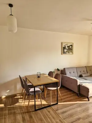 a living room with a table and chairs and a couch at Apartament Ruczaj - Parking & Self Check-in in Kraków
