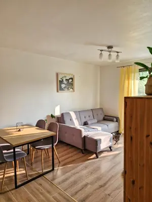 a living room with a couch and a table at Apartament Ruczaj - Parking & Self Check-in in Kraków