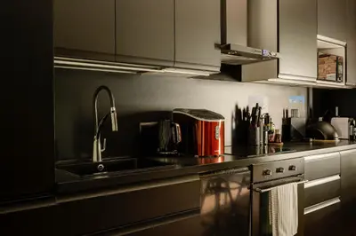 a kitchen with a sink and a counter top at Premium Black Apartment Krakow Center with Parking in Kraków