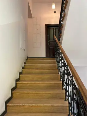 a stairway with wooden stairs and a door at Premium Black Apartment Krakow Center with Parking in Kraków