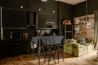 a kitchen with black walls and a table and a couch at Premium Black Apartment Krakow Center with Parking in Kraków