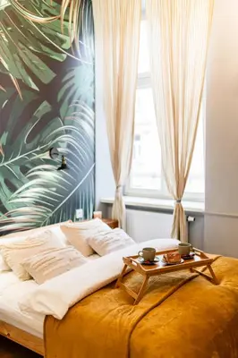 a bedroom with a bed with a table on it at Kraków Kazimierz - Top Location, Entresol - by Rentujemy in Kraków