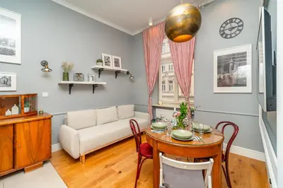 a living room with a table and a couch at Kraków Kazimierz - Top Location, Entresol - by Rentujemy in Kraków