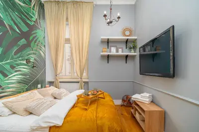 a bedroom with a bed and a tv on a wall at Kraków Kazimierz - Top Location, Entresol - by Rentujemy in Kraków