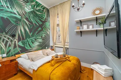a bedroom with a bed and a large mural at Kraków Kazimierz - Top Location, Entresol - by Rentujemy in Kraków