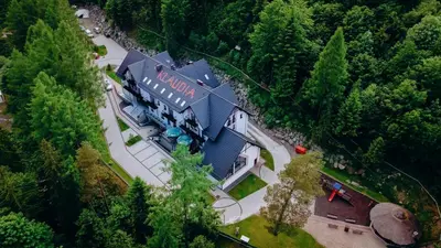 an overhead view of a large house in the woods at Hotel Klaudia in Juszczyn