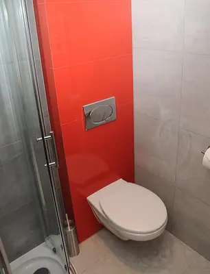 a small bathroom with a toilet and a shower at Hotel Klaudia in Juszczyn