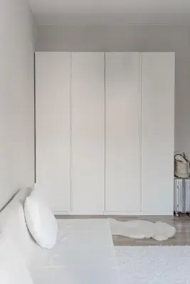 a white bedroom with a white bed with white pillows at Quiet Studio in the heart of Kazimierz AC in Kraków