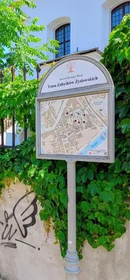 a sign in front of a building with graffiti at Quiet Studio in the heart of Kazimierz AC in Kraków