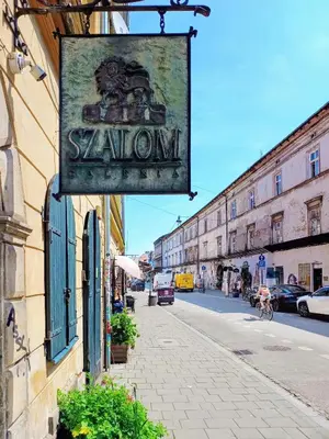 a sign on the side of a building on a street at Quiet Studio in the heart of Kazimierz AC in Kraków