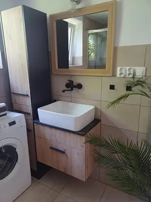 a bathroom with a sink and a washing machine at Wieliczka4You in Wieliczka