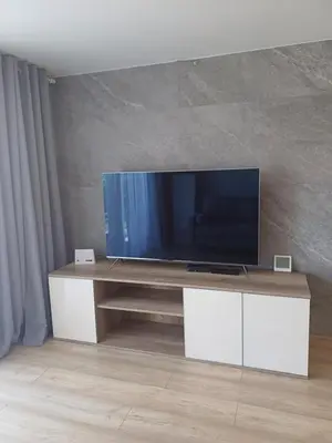a living room with a flat screen tv on a table at Wieliczka4You in Wieliczka
