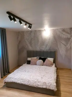 a bedroom with a large bed with pillows on it at Wieliczka4You in Wieliczka