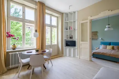 a bedroom with a bed and a table and chairs at lovely place, modern design, historic townhouse in Kraków