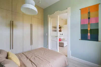 a room with a bed and a door to a room at lovely place, modern design, historic townhouse in Kraków