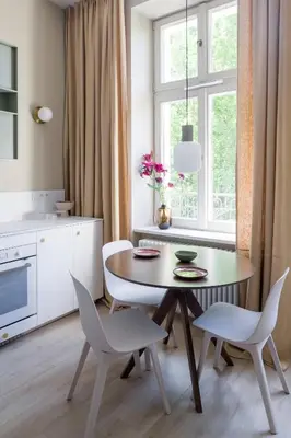 a kitchen with a table and chairs and a window at lovely place, modern design, historic townhouse in Kraków
