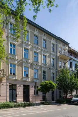 a large brick building on the side of a street at lovely place, modern design, historic townhouse in Kraków