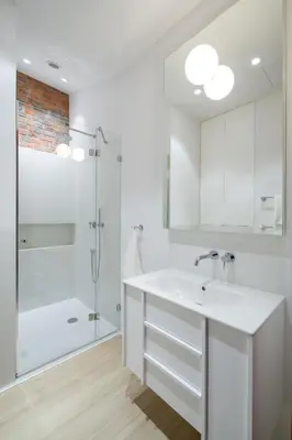 a white bathroom with a sink and a shower at lovely place, modern design, historic townhouse in Kraków